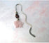 A Dragon Bookmark with a rose quartz carved dragon, perfect for fantasy and mystery readers, is shown as a bullet journal page marker on a light pastel background.