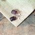 Tortoise Earrings: Optic Amethyst Purple Glass Animal Jewelry with silver hooks, displayed on textured beige fabric atop rustic wood—ideal for animal jewelry lovers.