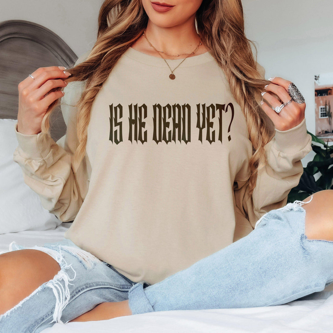 May include: A tan long-sleeved sweatshirt with the text &amp;