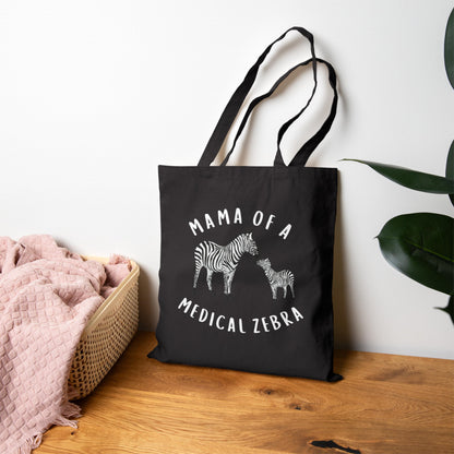 May include: A black tote bag with white text and images. The text reads &amp;