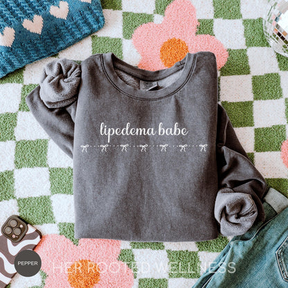 May include: A dark gray sweatshirt with the words &amp;
