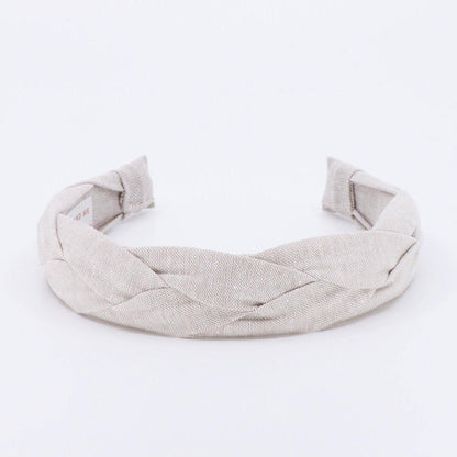 A light tan braided linen headband.
