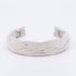A light tan braided linen headband.