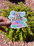 May include: A colorful sticker with the words &