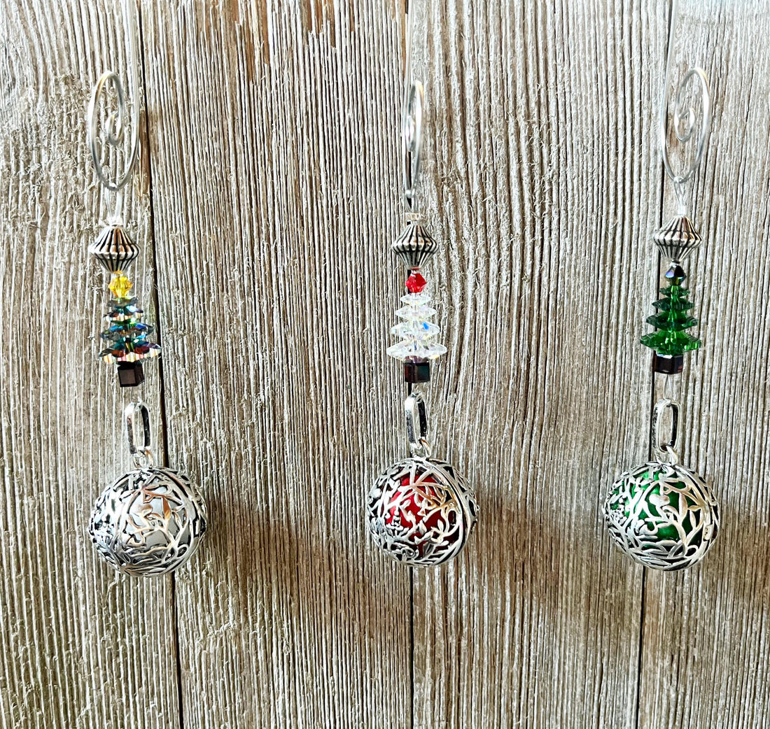 Three Gwynstone Scent Locket Christmas Ornaments, each featuring a small crystal Christmas tree charm above a silver filigree locket containing a colored sphere.