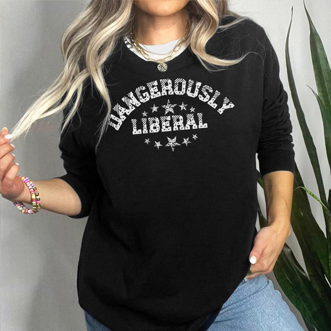 May include: Black sweatshirt with long sleeves and a crew neck.  The front features a white arched graphic that says &amp;