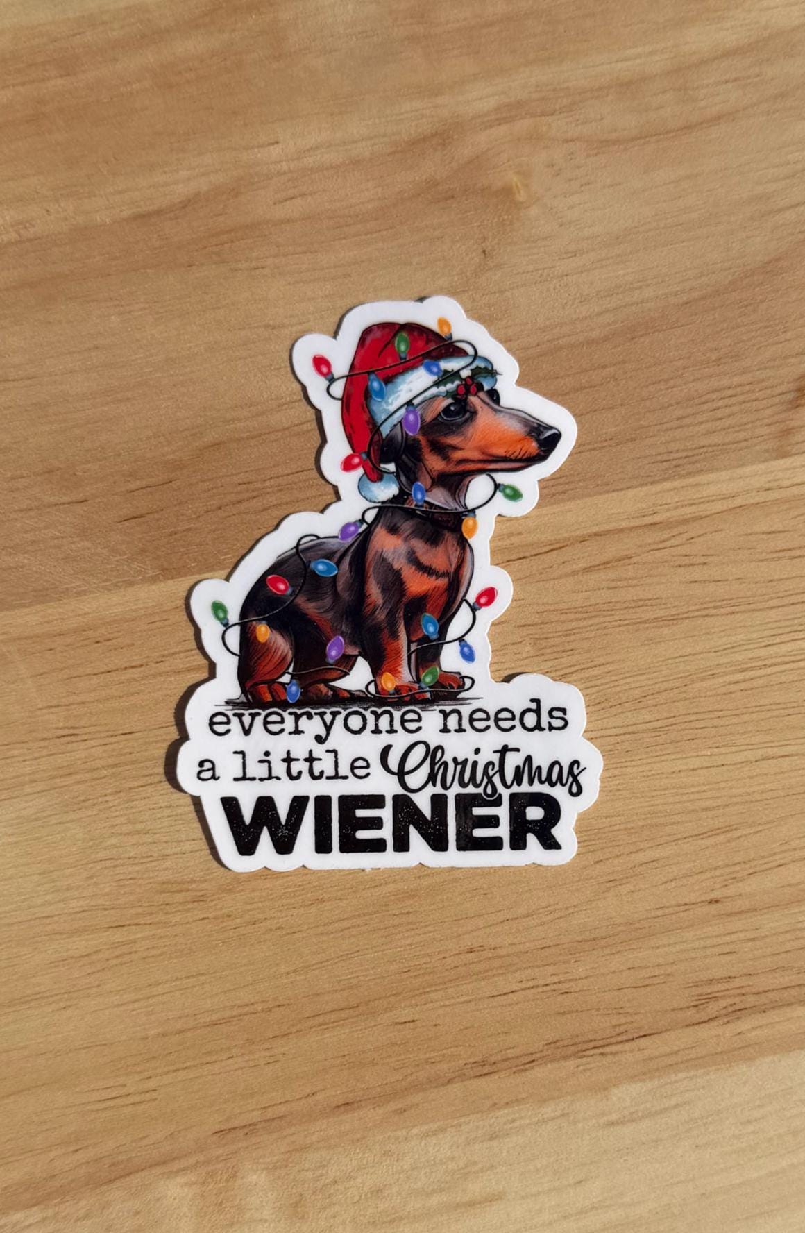 Everyone Needs a Little Christmas Wiener – Dachshund Holiday Sticker (2” or 3”) — Clear or Holographic