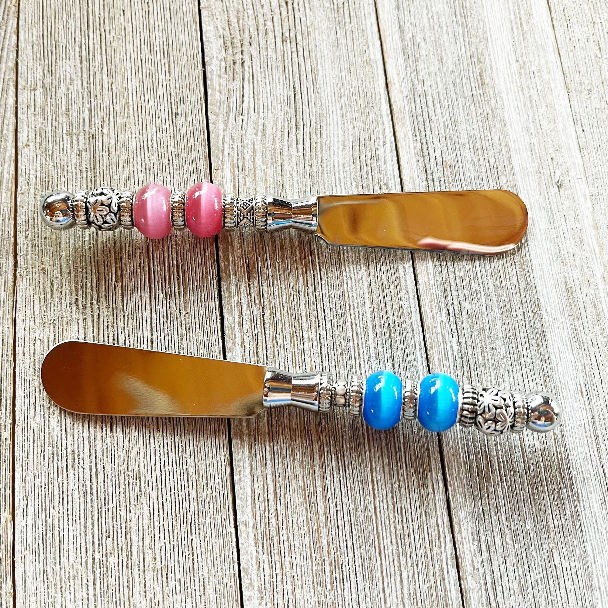 The Gender Reveal Party Spreader set includes beaded dip knives in pink and blue, perfect as charming spreaders for baby showers or gender reveal parties.