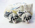 A pair of Raccoon Earrings featuring handpainted garbage panda charms with silver lever backs—perfect as a nature lover gift—displayed in front of a pale stone background.