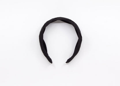 May include: A black braided headband made of fabric.