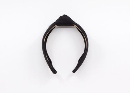 May include: A black knotted headband made of linen fabric. The headband has a label that says &amp;quot;MADDIE AND ME&amp;quot;.