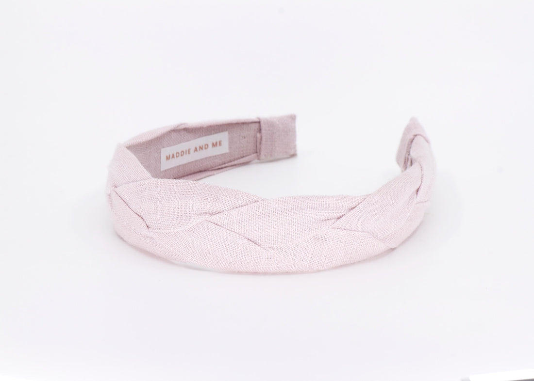A light tan braided linen headband. The headband has a label that says &amp;quot;MADDIE AND ME&amp;quot;.