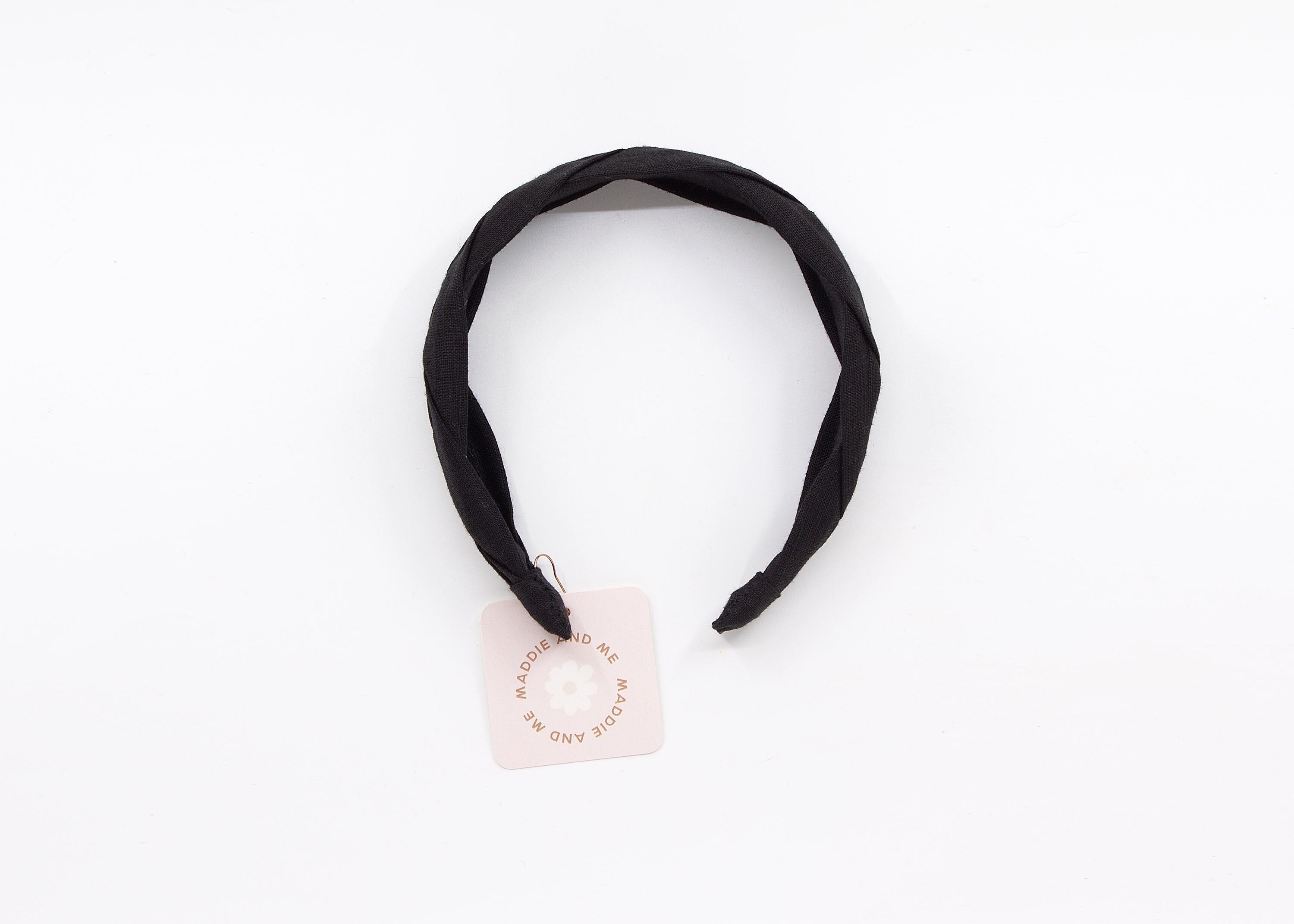 May include: A black braided headband made of fabric. A tag with the text &amp;quot;MADDIE AND ME&amp;quot; is attached.