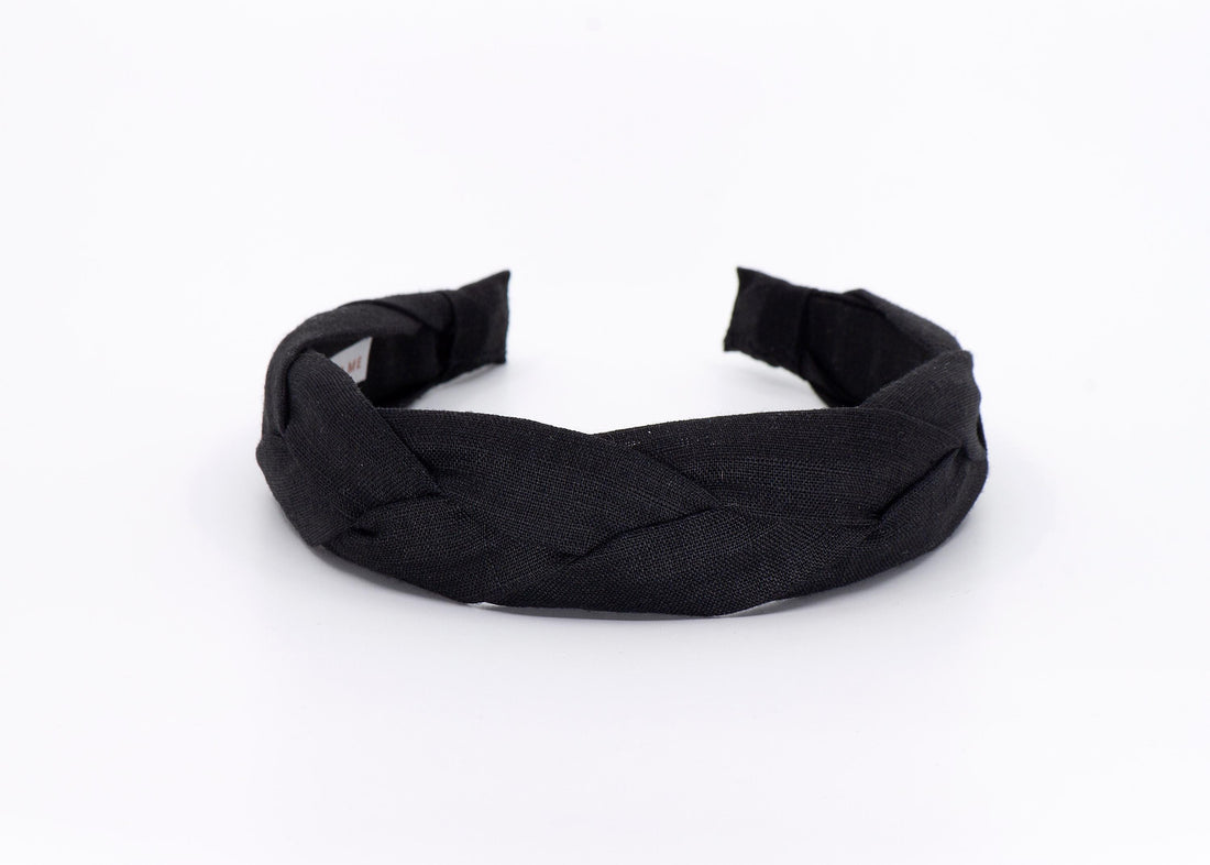 A black braided headband made of linen fabric.