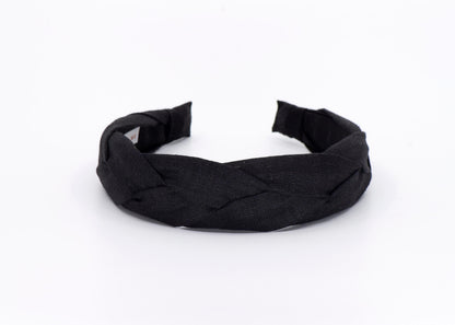 A black braided headband made of linen fabric.