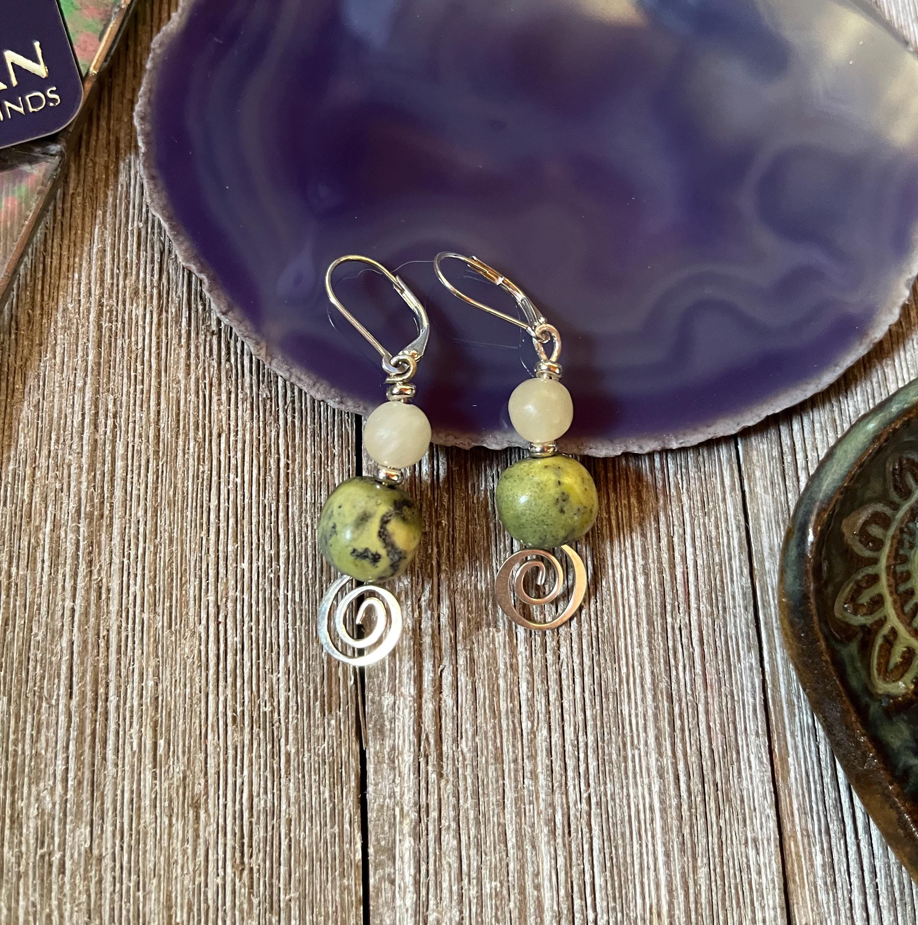 Handmade Citrine African Turquoise Earrings: Spring Swirl Silver Jewelry—featuring citrine, turquoise stones, and silver swirl charms—bring an elegant accent to your collection. Displayed on a purple dish over wood for a stylish touch.