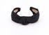 May include: A black knotted headband made of linen fabric.