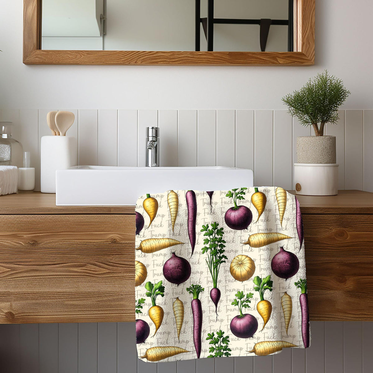 Towel with a repeating pattern of carrots, radishes, and onions.
