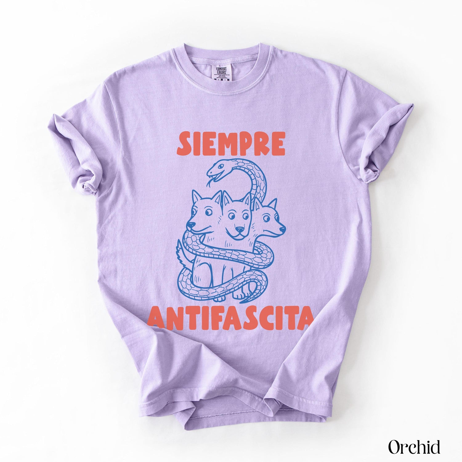 Lavender t-shirt with blue ink illustration of three-headed dog and text &amp;quot;SIEMPRE ANTIFASCISTA&amp;quot;.