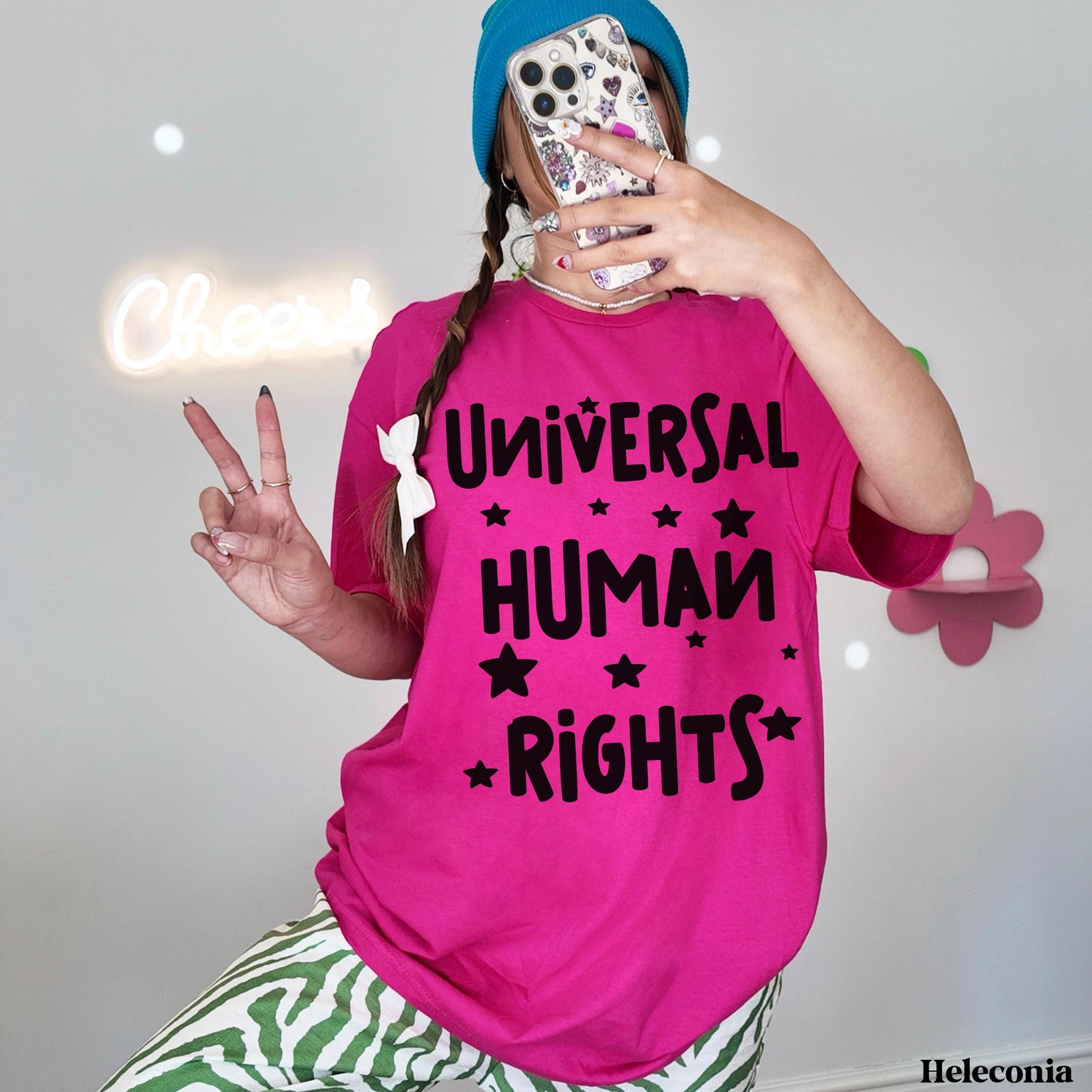 Young person in pink t-shirt with &amp;quot;UNIVERSAL HUMAN RIGHTS&amp;quot; text, peace sign.