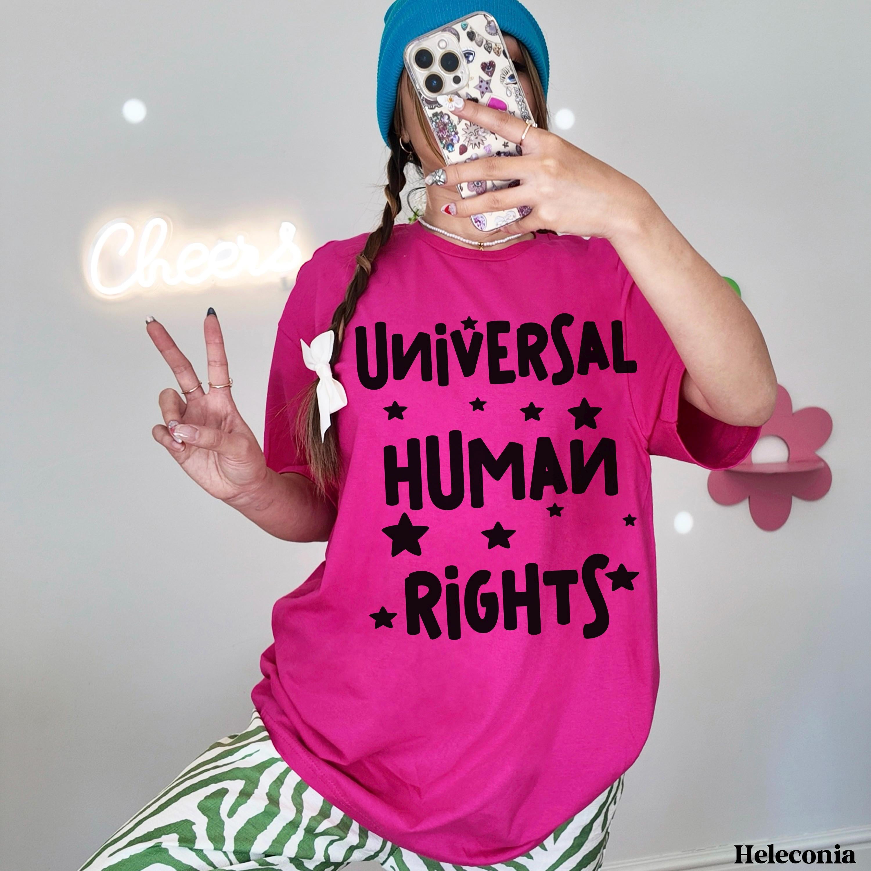 Young person in pink t-shirt with &amp;quot;UNIVERSAL HUMAN RIGHTS&amp;quot; text, peace sign.