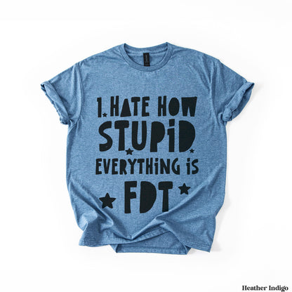 Heather indigo t-shirt with black text stating &amp;quot;I HATE HOW STUPID EVERYTHING IS&amp;quot; and a star.