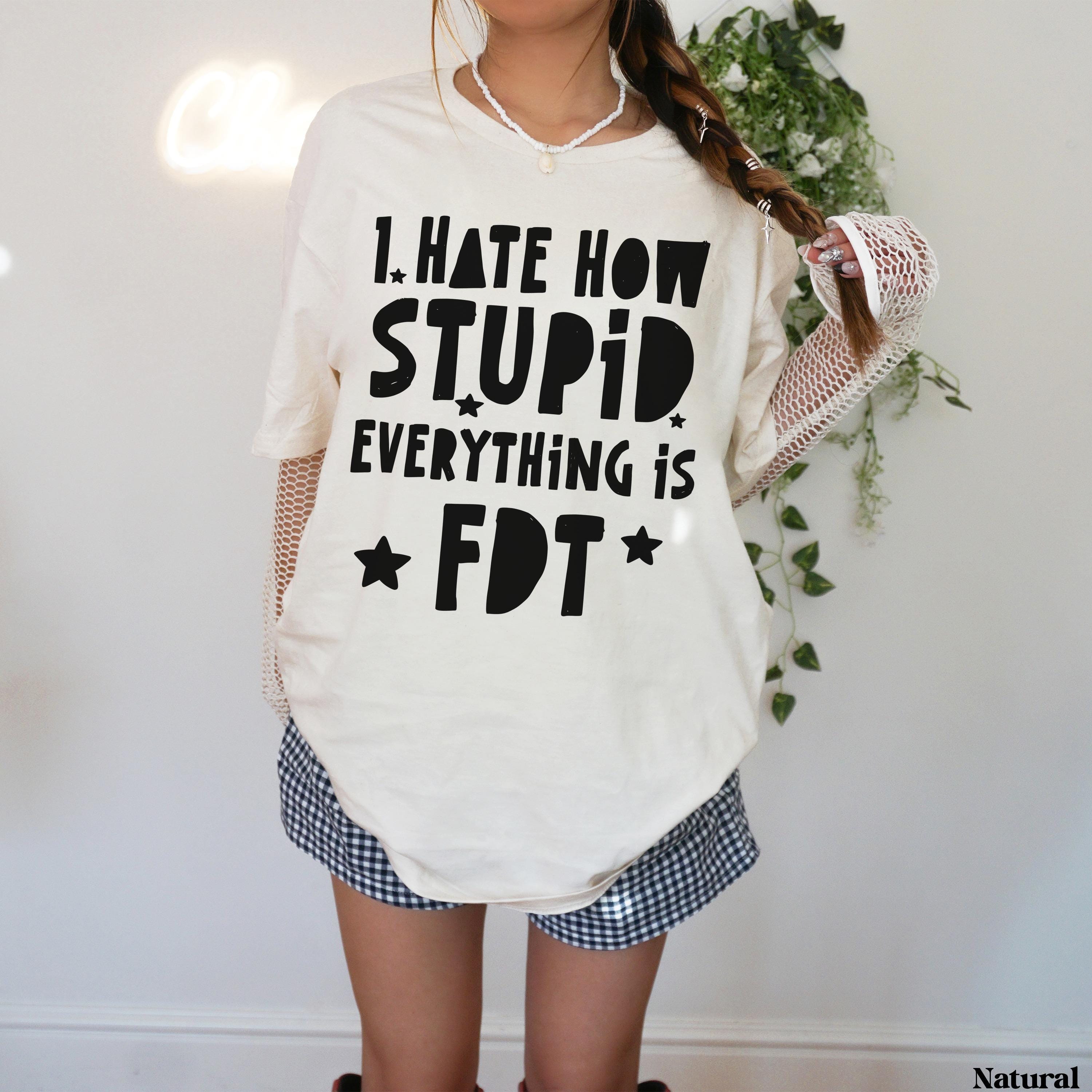 Cream t-shirt with &amp;quot;I HATE HOW STUPID EVERYTHING IS&amp;quot; text and star graphics.