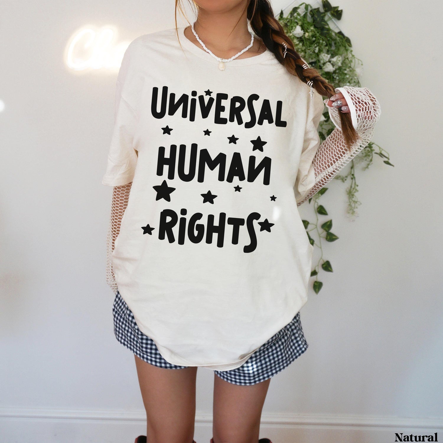 Cream t-shirt with &amp;quot;Universal Human Rights&amp;quot; in black text and stars.