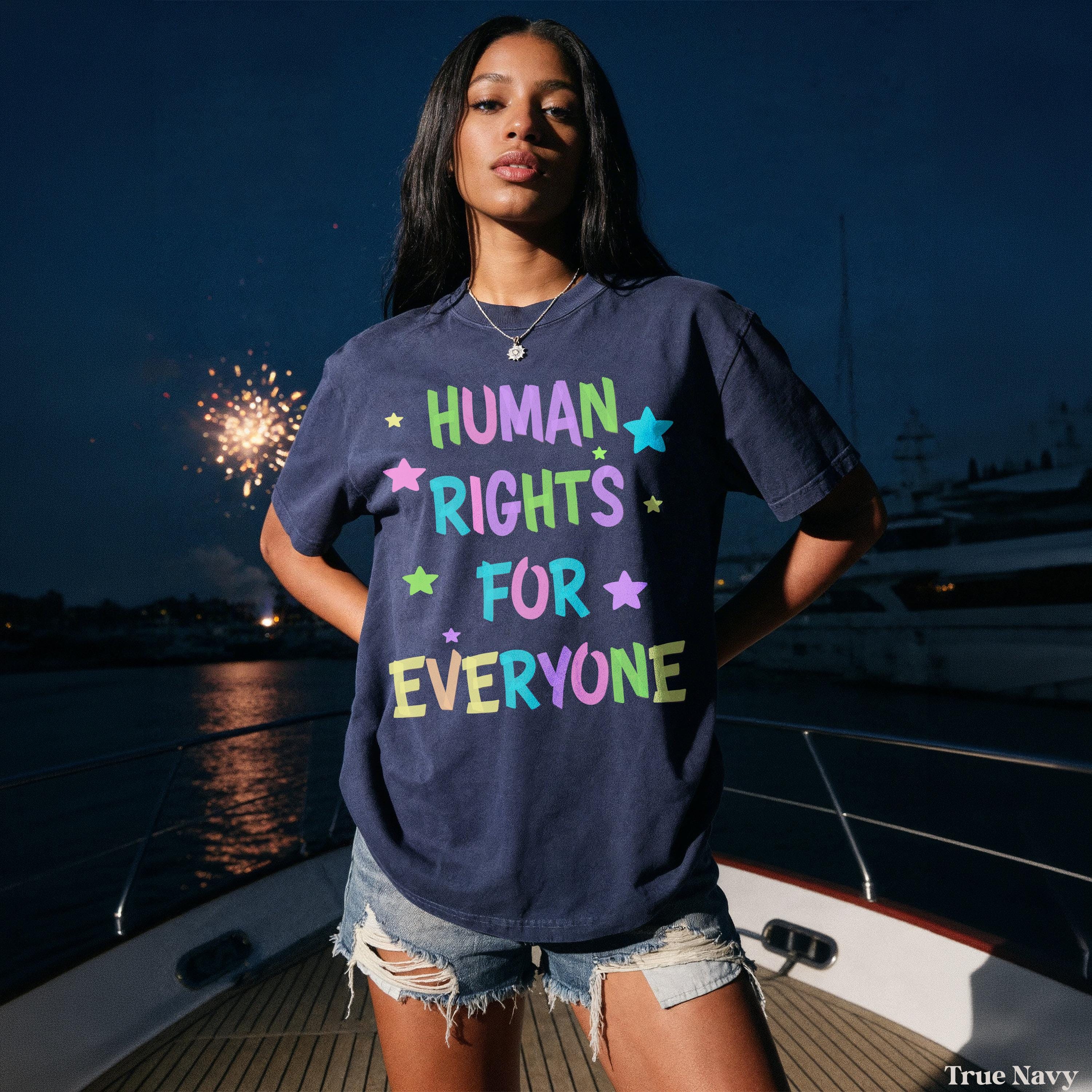 Woman in navy t-shirt with &amp;quot;Human Rights for Everyone&amp;quot; text, standing on a boat.