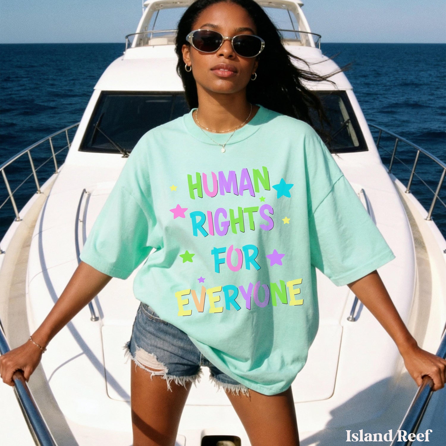 Woman wearing a mint green t-shirt with &amp;quot;HUMAN RIGHTS FOR EVERYONE&amp;quot; text and stars.