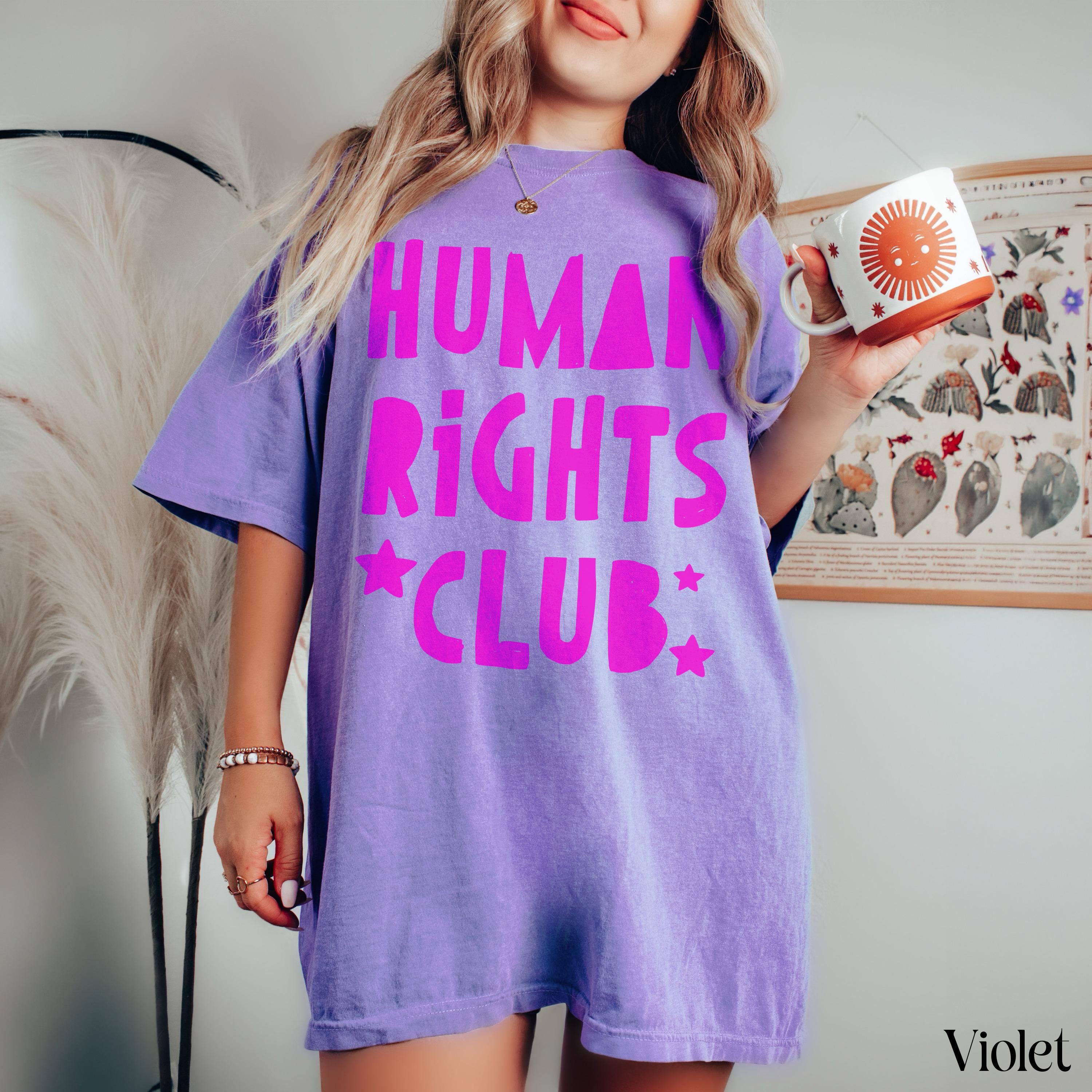 Purple t-shirt with &amp;quot;Human Rights Club&amp;quot; and stars in bright pink lettering.