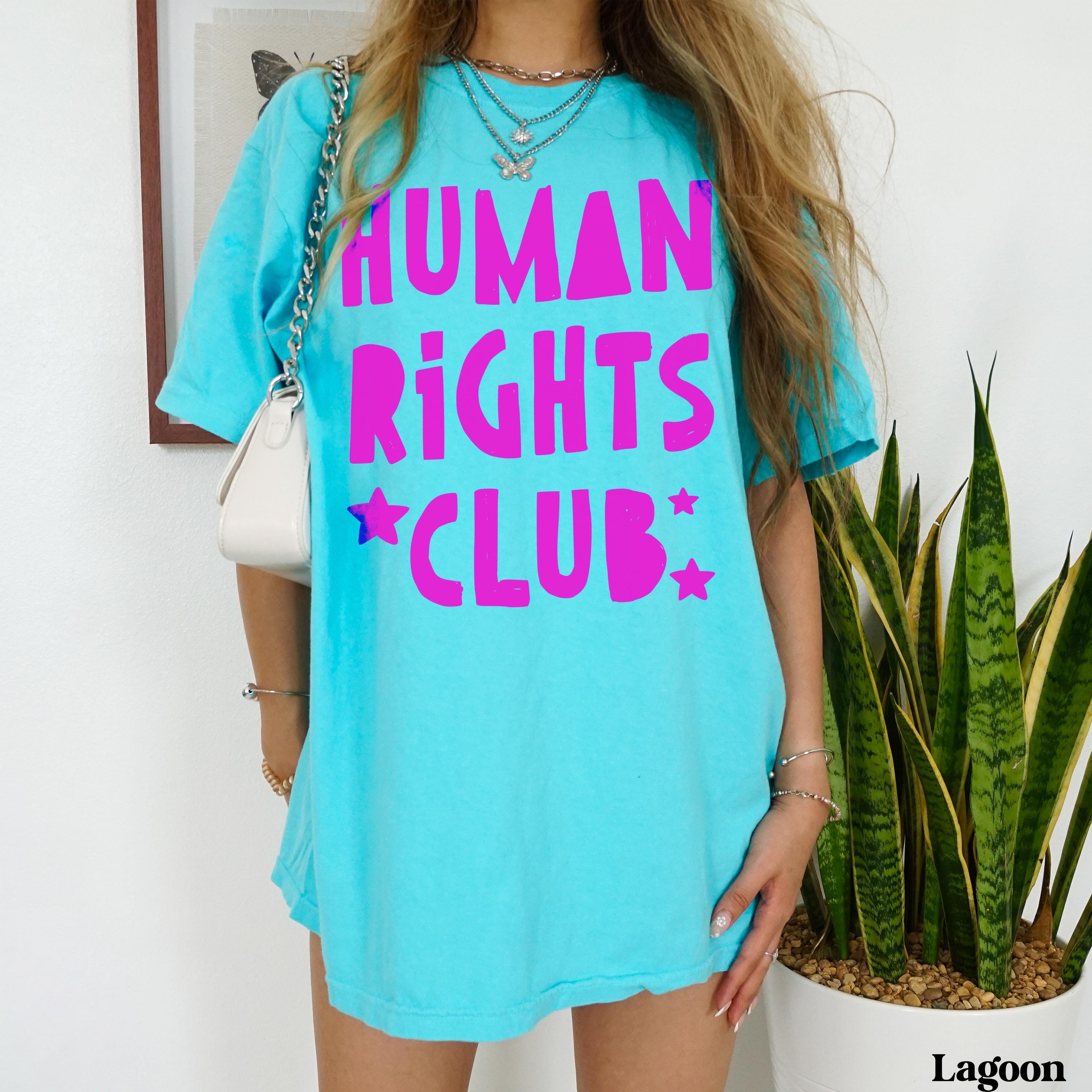 Cyan t-shirt with &amp;quot;Human Rights Club&amp;quot; in magenta text and star accents.