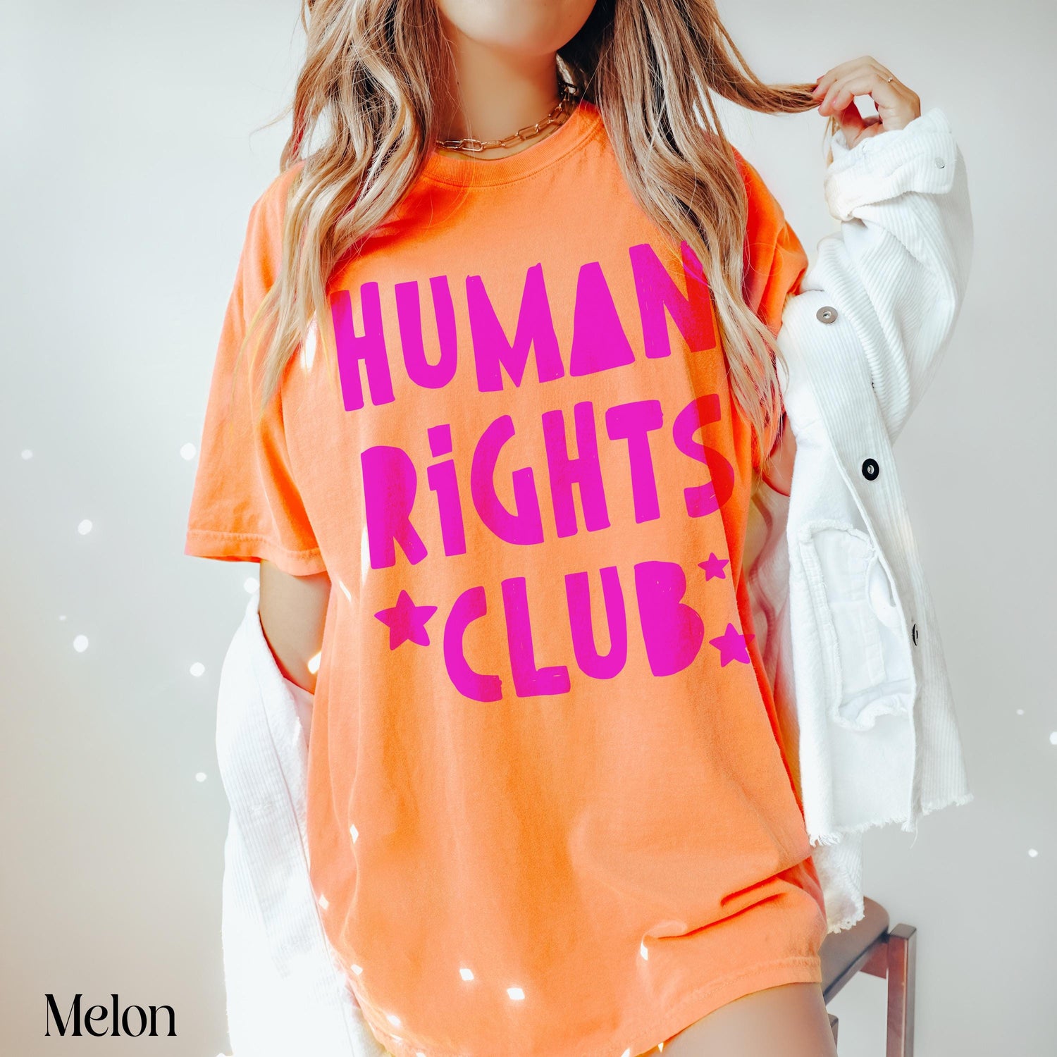 Orange t-shirt with &amp;quot;Human Rights Club&amp;quot; and stars in hot pink.
