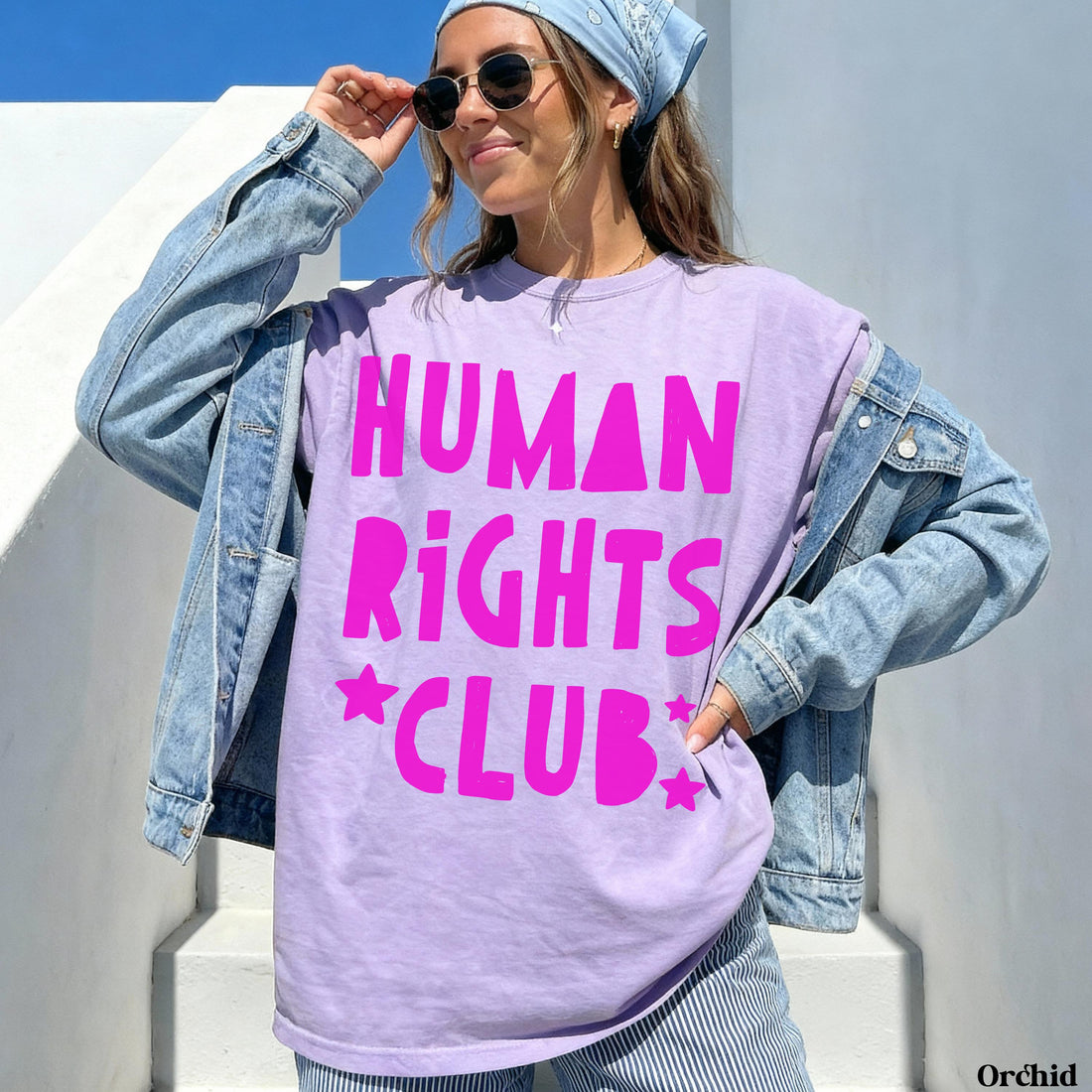 Woman wearing purple t-shirt with &amp;quot;HUMAN RIGHTS CLUB&amp;quot; in pink text.