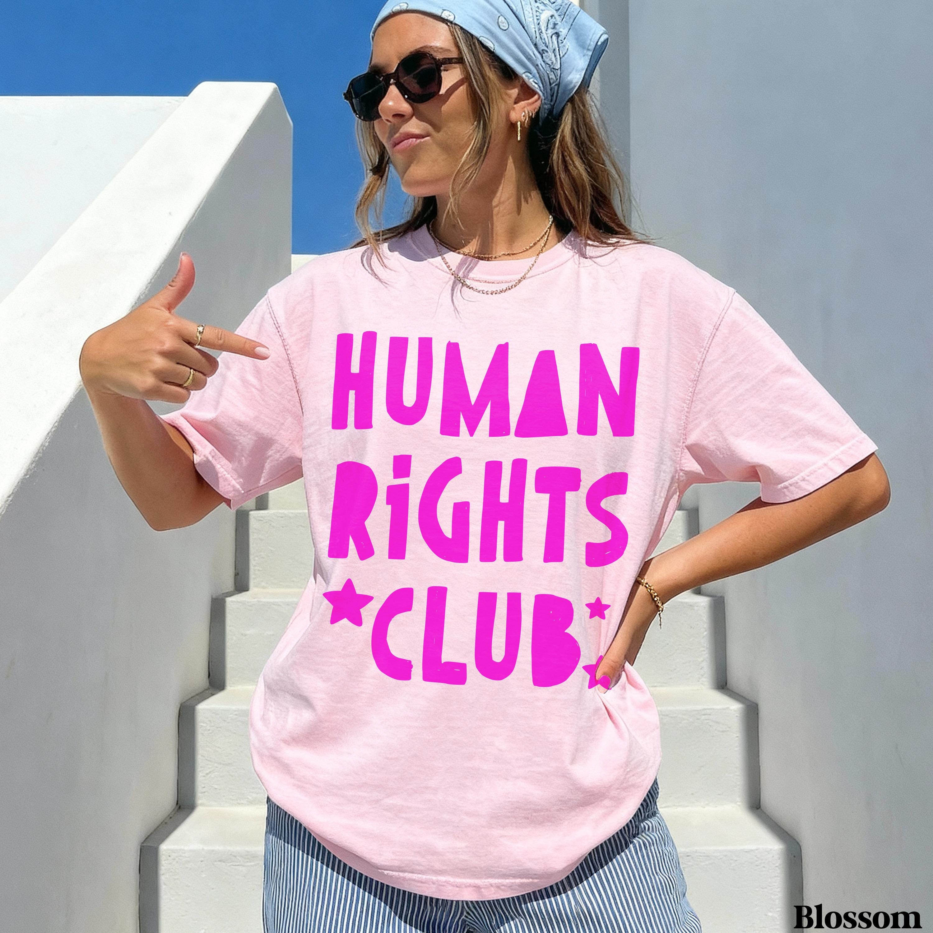 Woman wearing pink t-shirt with &amp;quot;HUMAN RIGHTS CLUB&amp;quot; text and star accents.