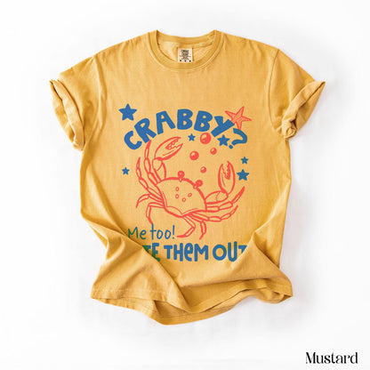 Mustard t-shirt with red crab graphic saying &amp;quot;CRABBY? Me too! LET THEM OUT!&amp;quot;.