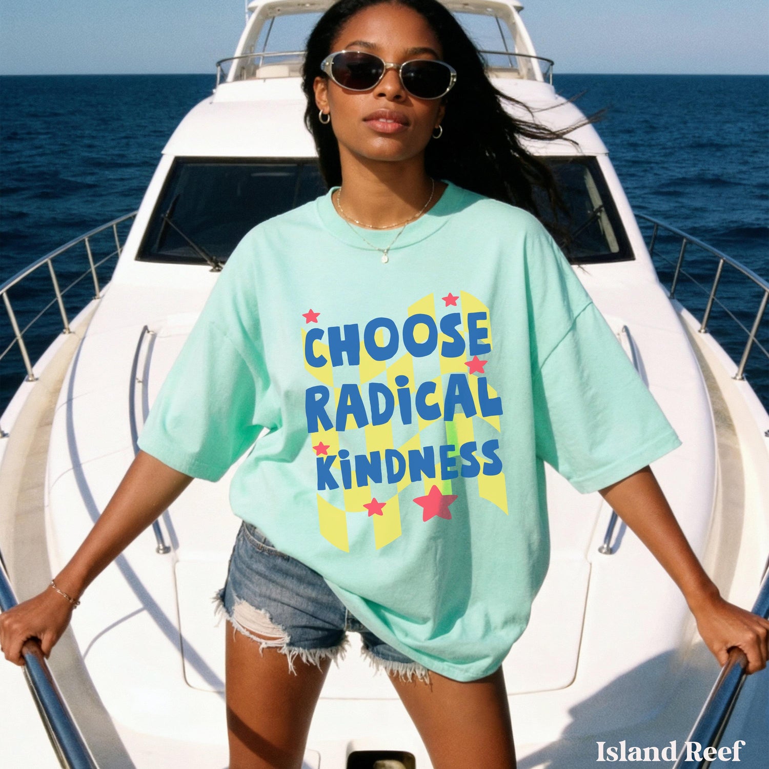 Woman in mint t-shirt with &amp;quot;CHOOSE RADICAL KINDNESS&amp;quot; text stands on a boat.