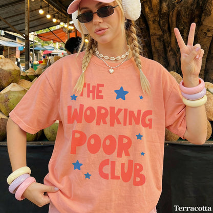 Woman wearing &amp;quot;The Working Poor Club&amp;quot; graphic tee, holding up peace sign.