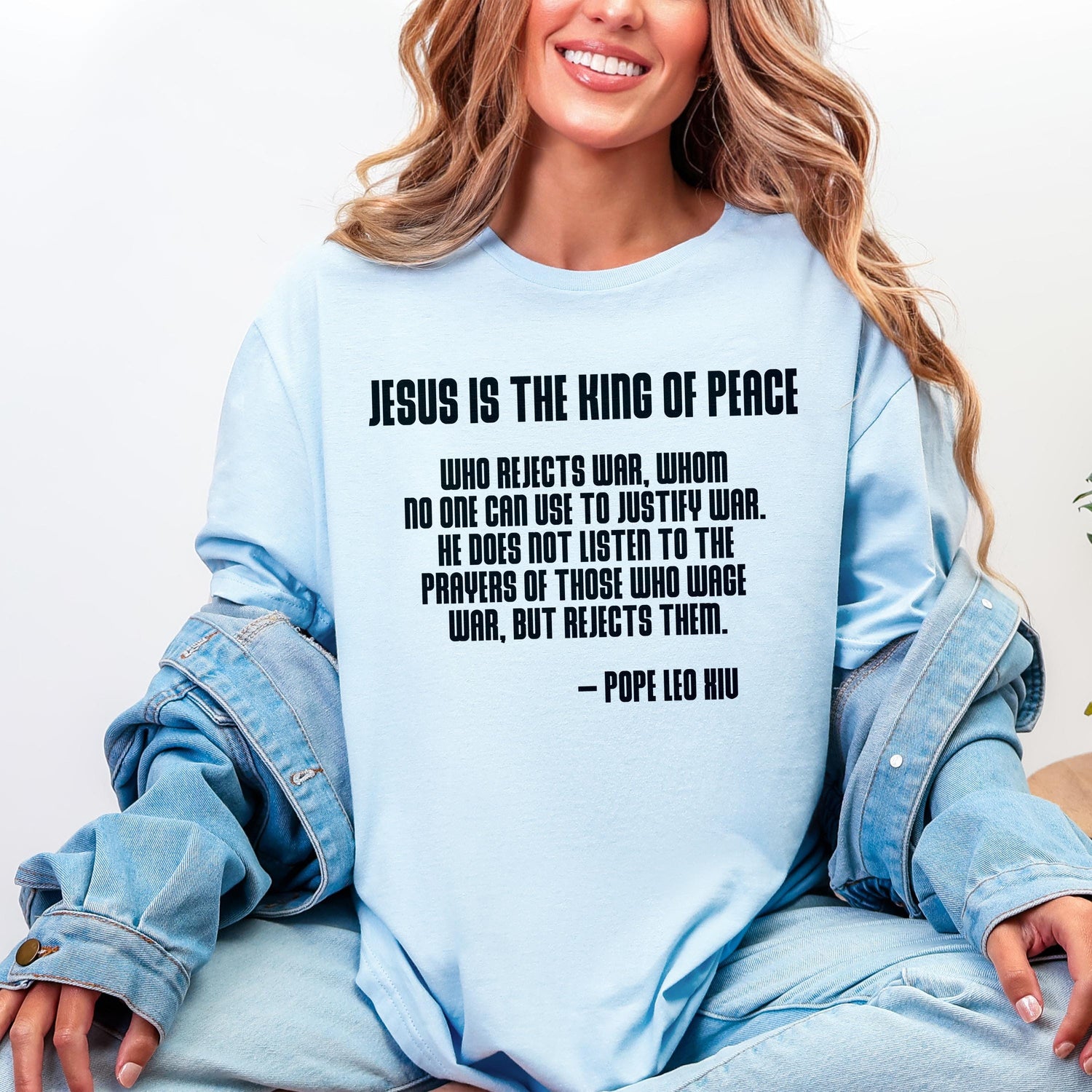 Light blue t-shirt with quote from Pope Leo XIU about Jesus and war.