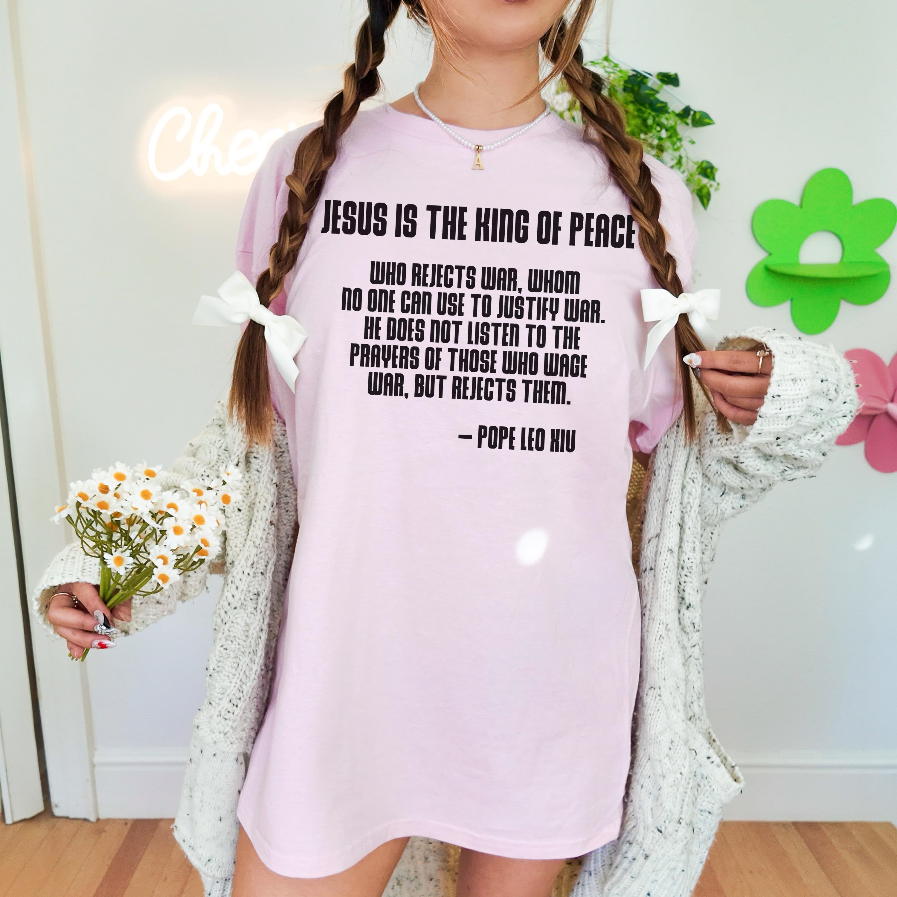 Pink t-shirt with quote from Pope Leo XIII about peace.