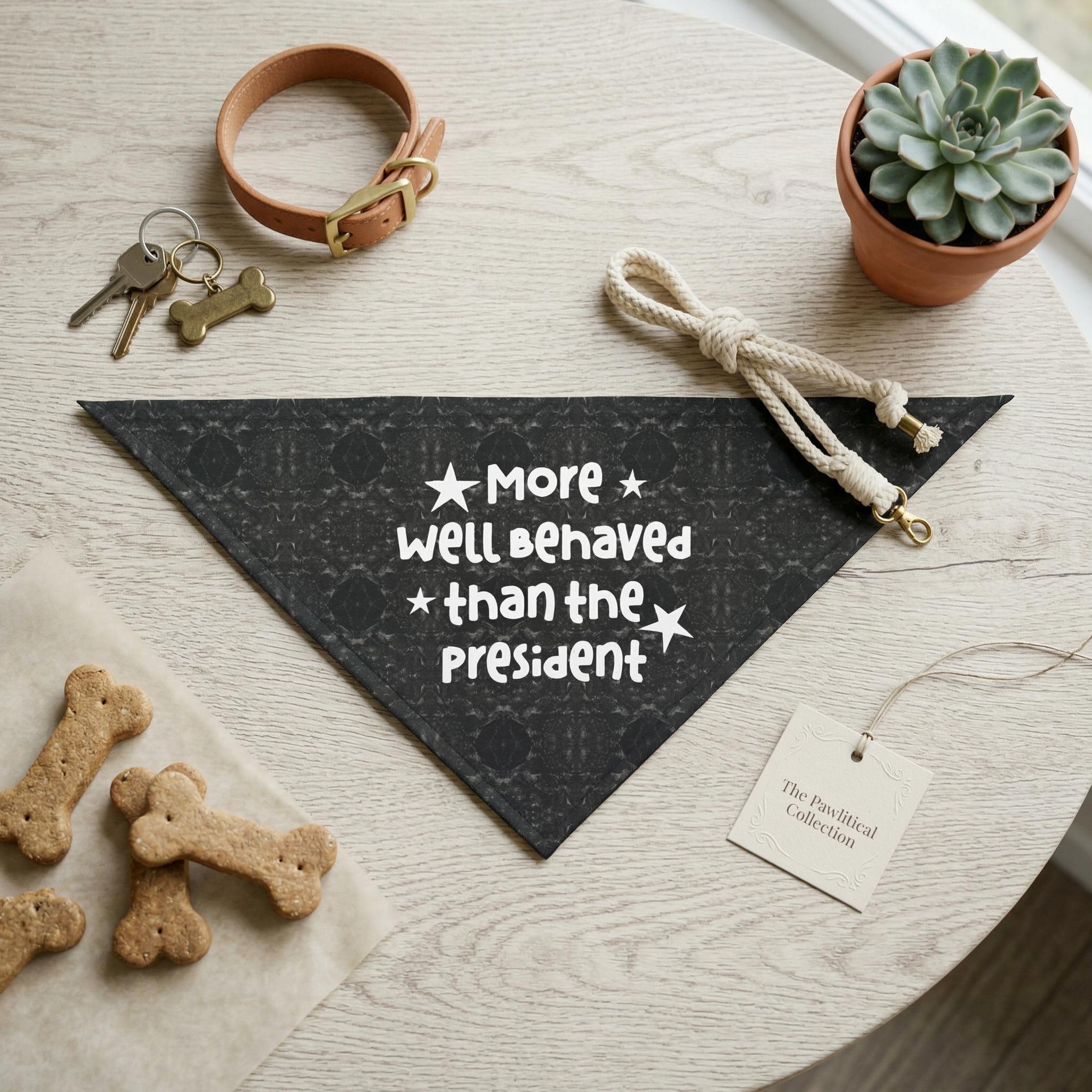 Black patterned dog bandana with text &amp;quot;More * well behaved * than the President&amp;quot;.