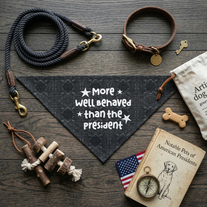 Dark bandana with &amp;quot;More well Behaved than the President&amp;quot; text, dog collar, rope, toy, and book.