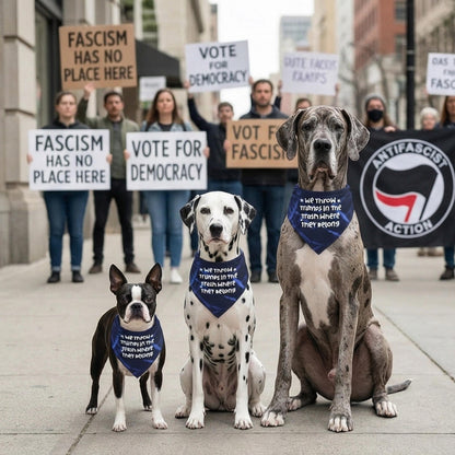 Three dogs wearing bandanas with a political slogan, marching.