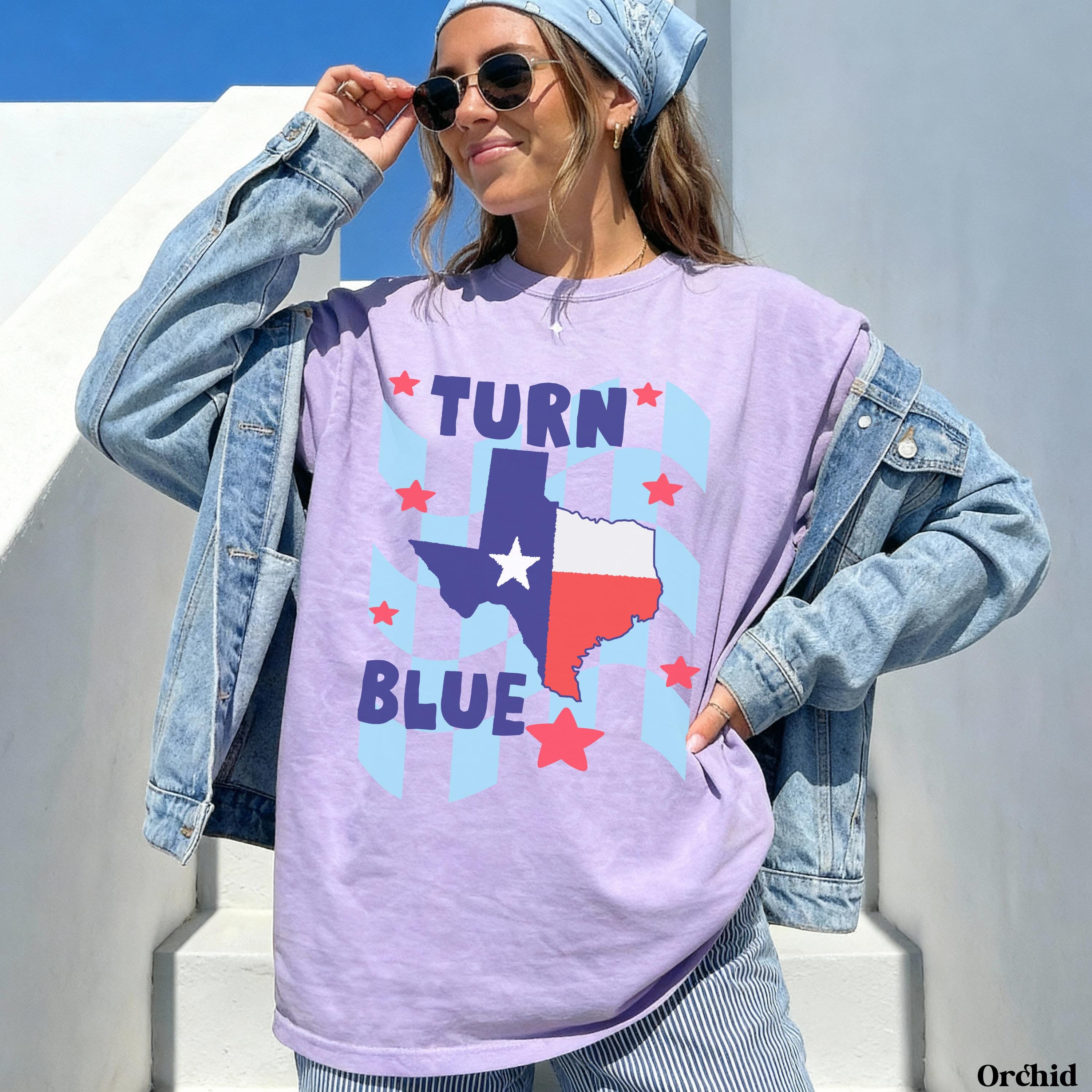 Purple t-shirt with Texas flag and &amp;quot;Turn Blue&amp;quot; text.
