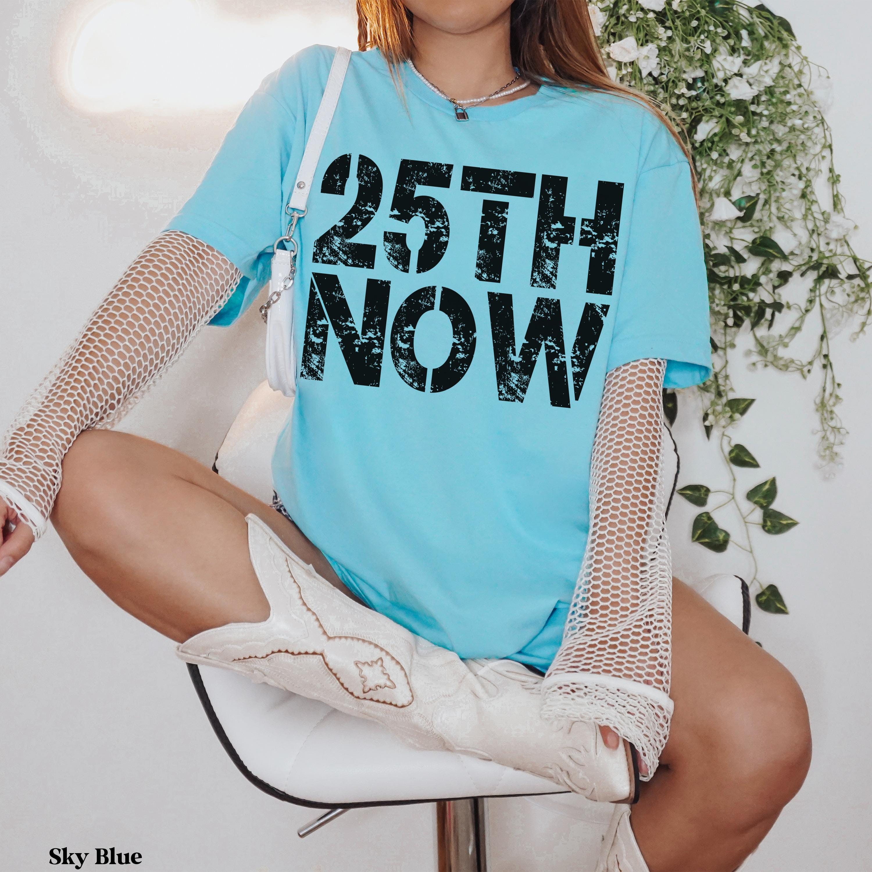 Light blue t-shirt with &amp;quot;25TH NOW&amp;quot; in black text.