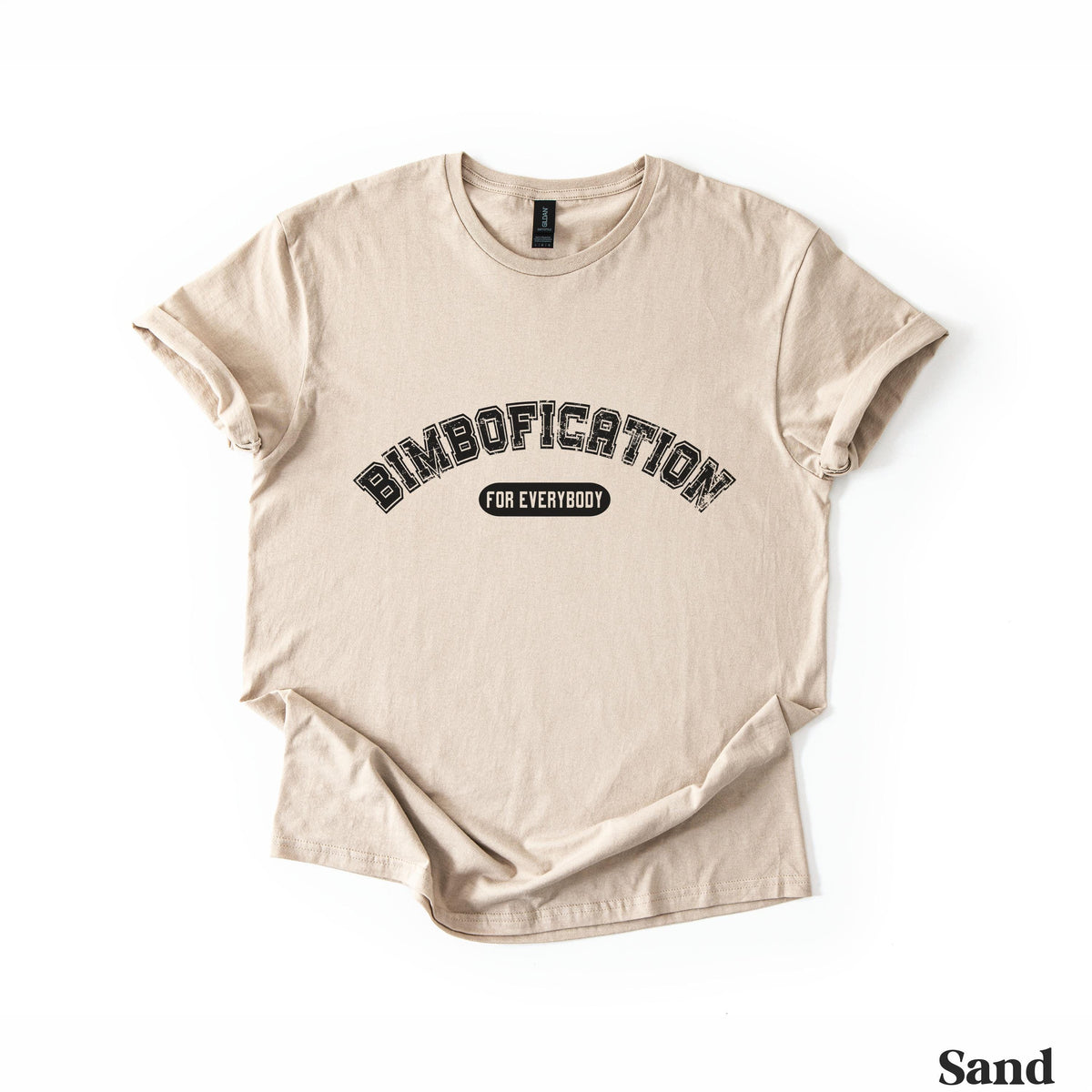 Sand t-shirt with &amp;quot;BIMBOFICATION FOR EVERYBODY&amp;quot; in arched black text.