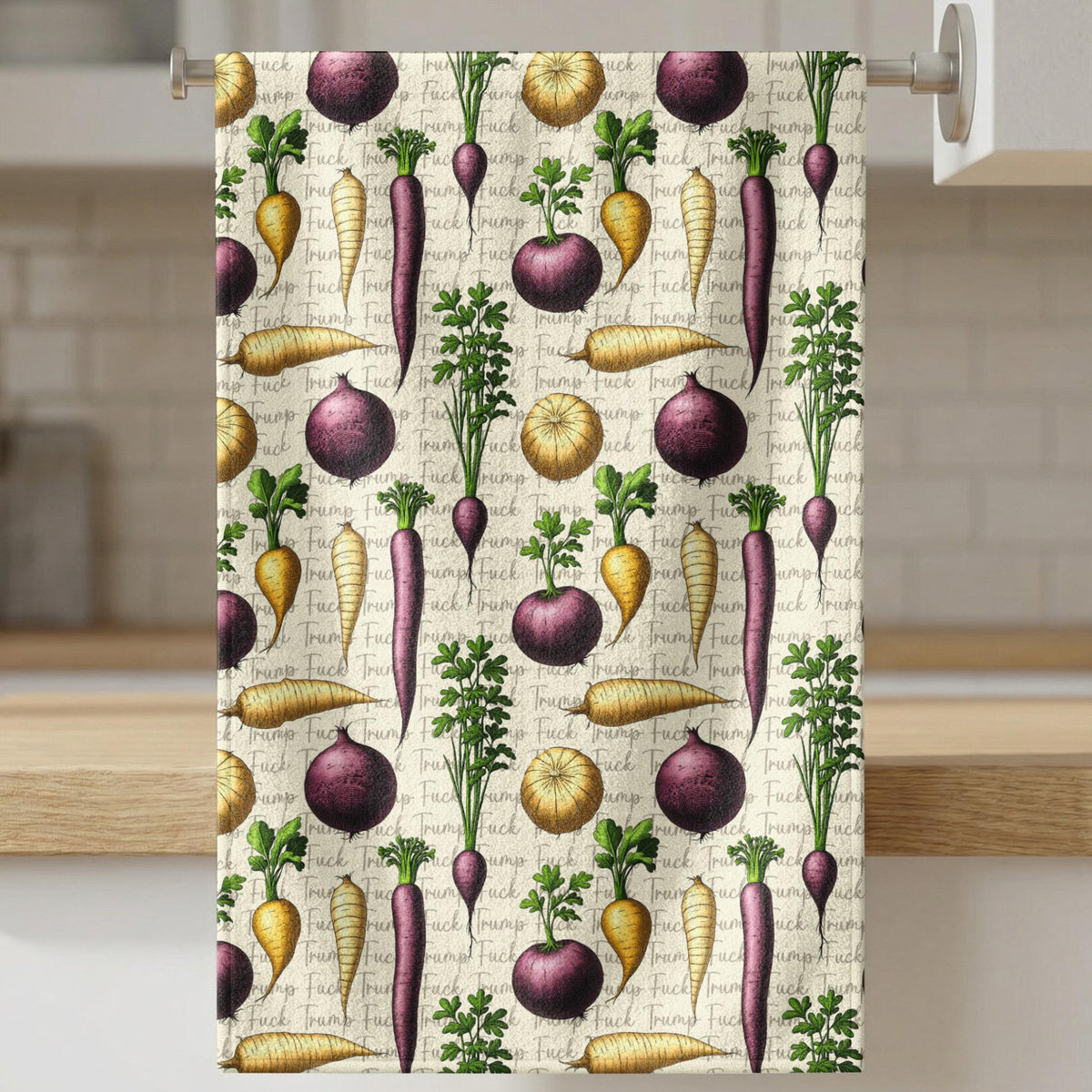 Towel with repeating pattern of carrots, radishes, and onions on text background.