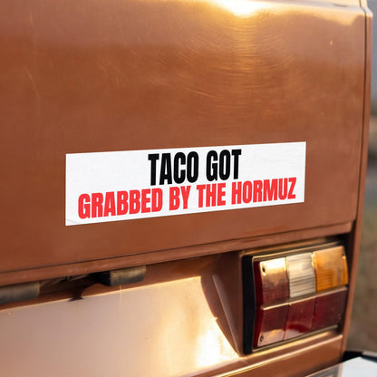 TACO GOT GRABBED BY THE HORMUZ bumper sticker on a brown car.