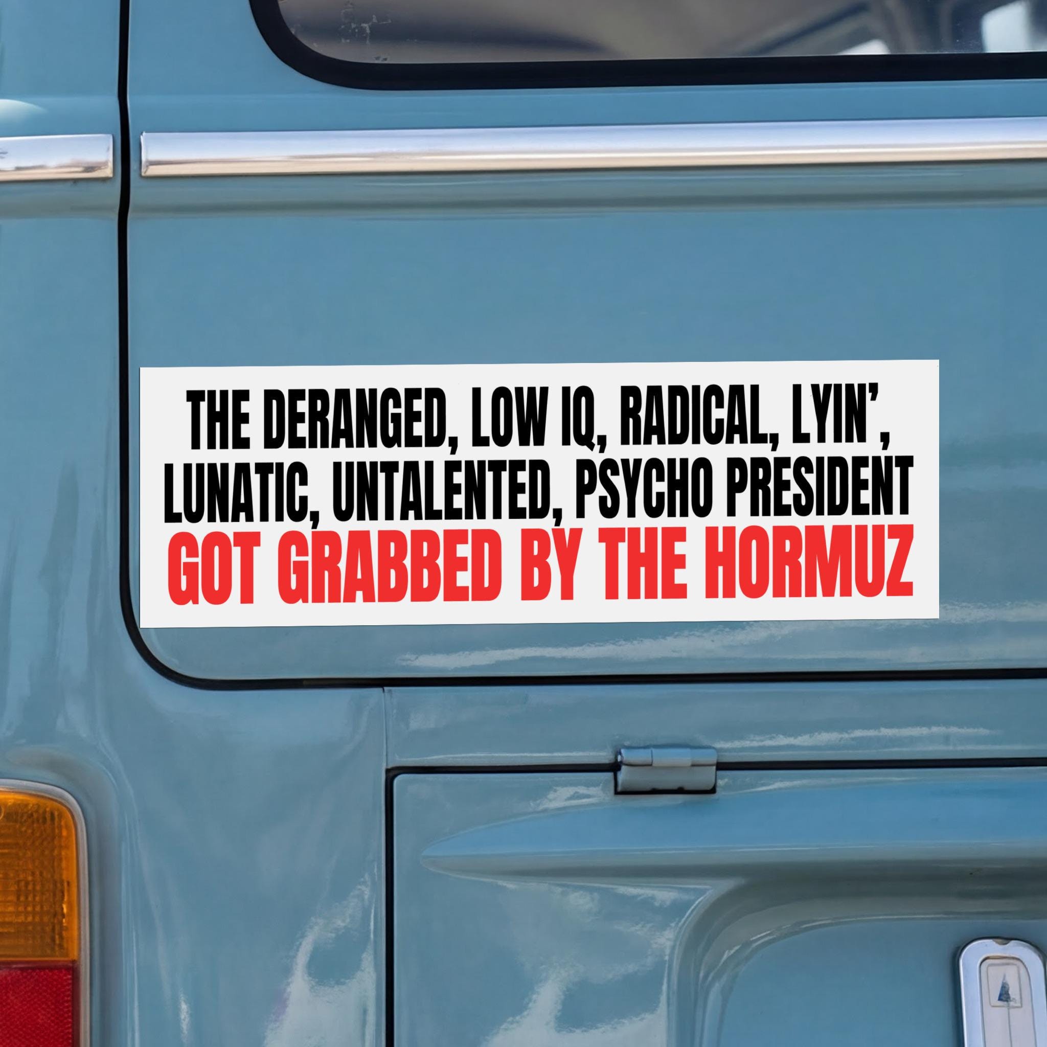 Sticker on blue vehicle reads &amp;quot;THE DERANGED, LOW IQ, RADICAL, LYIN&amp;