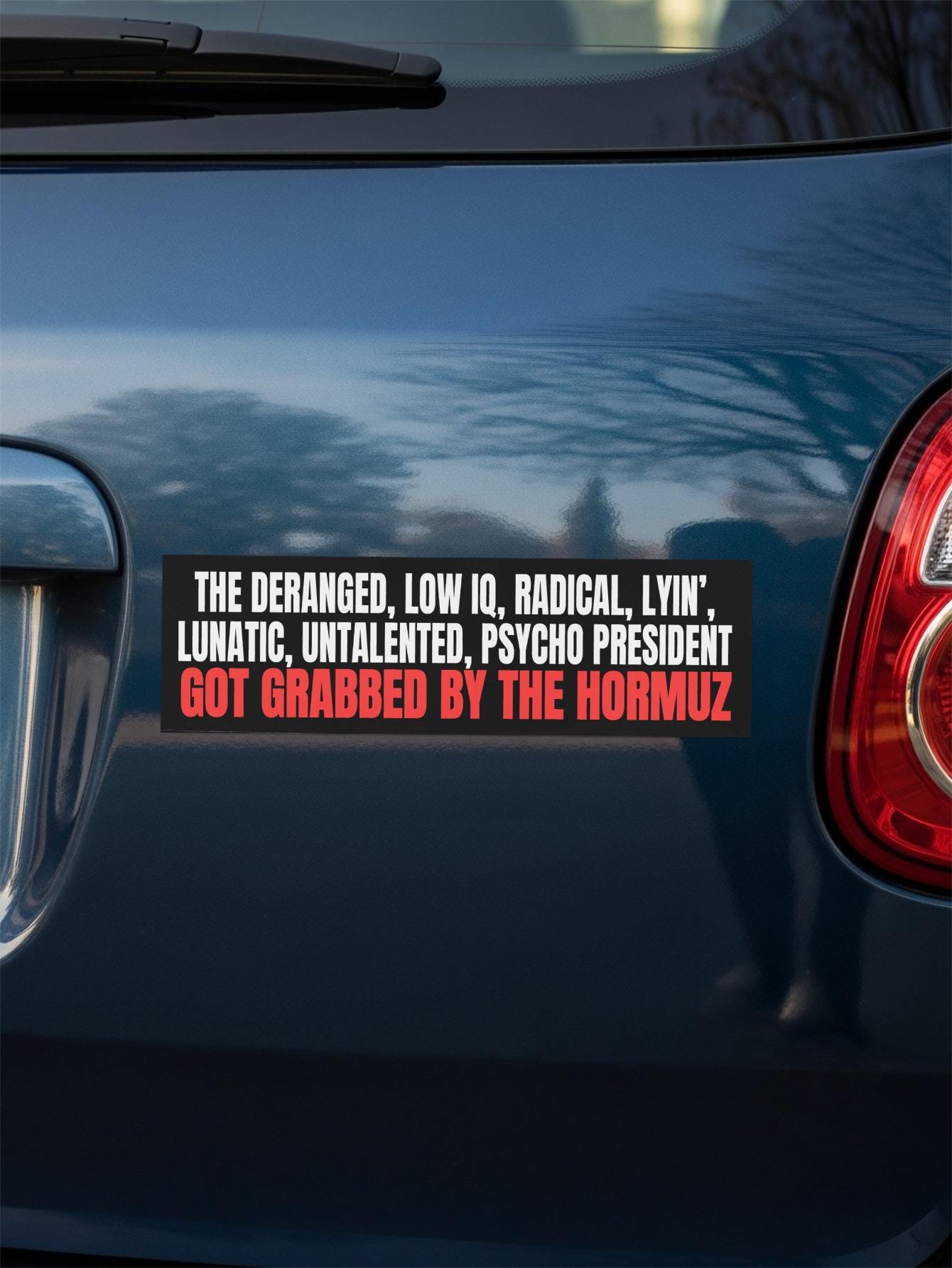 Bumper sticker with text about a president and the Hormuz Strait.